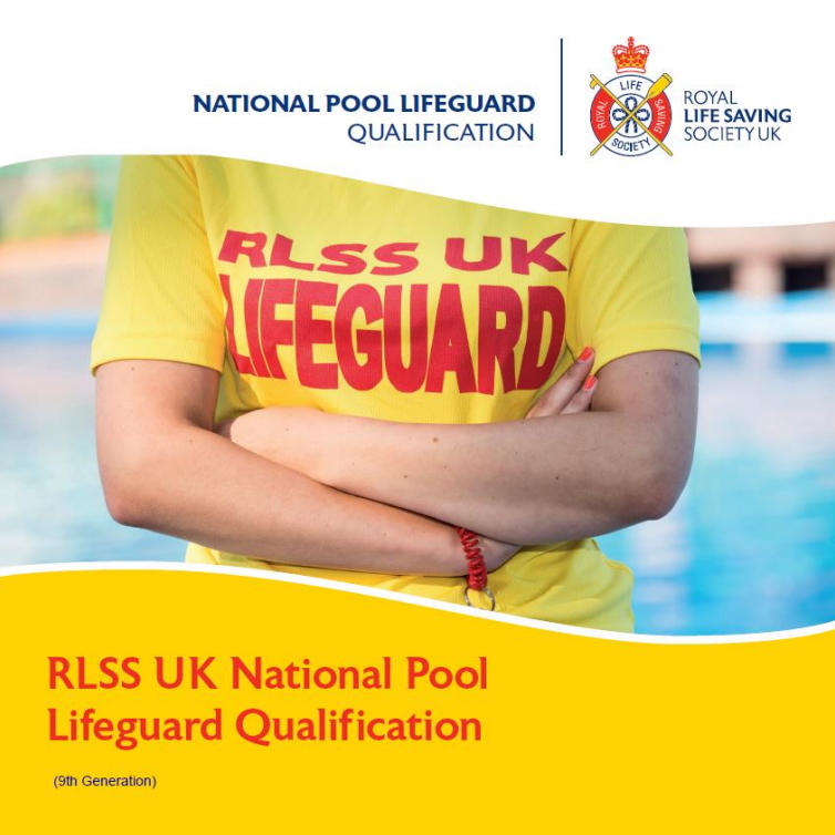 RLSS UK National Pool Lifeguard Qualification - Mid section of a lifeguard by a pool wearing a yellow t-shirt with arms folded