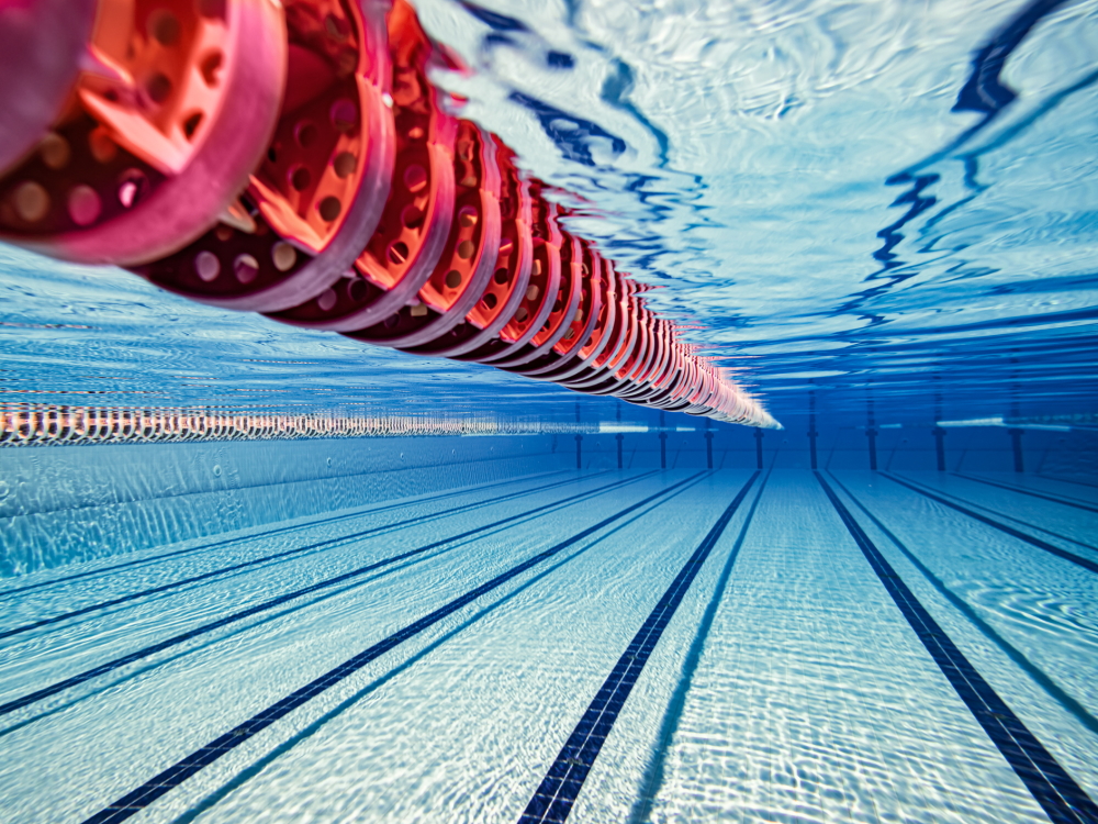 Underwater at an Olympic pool with a red lane rope visible